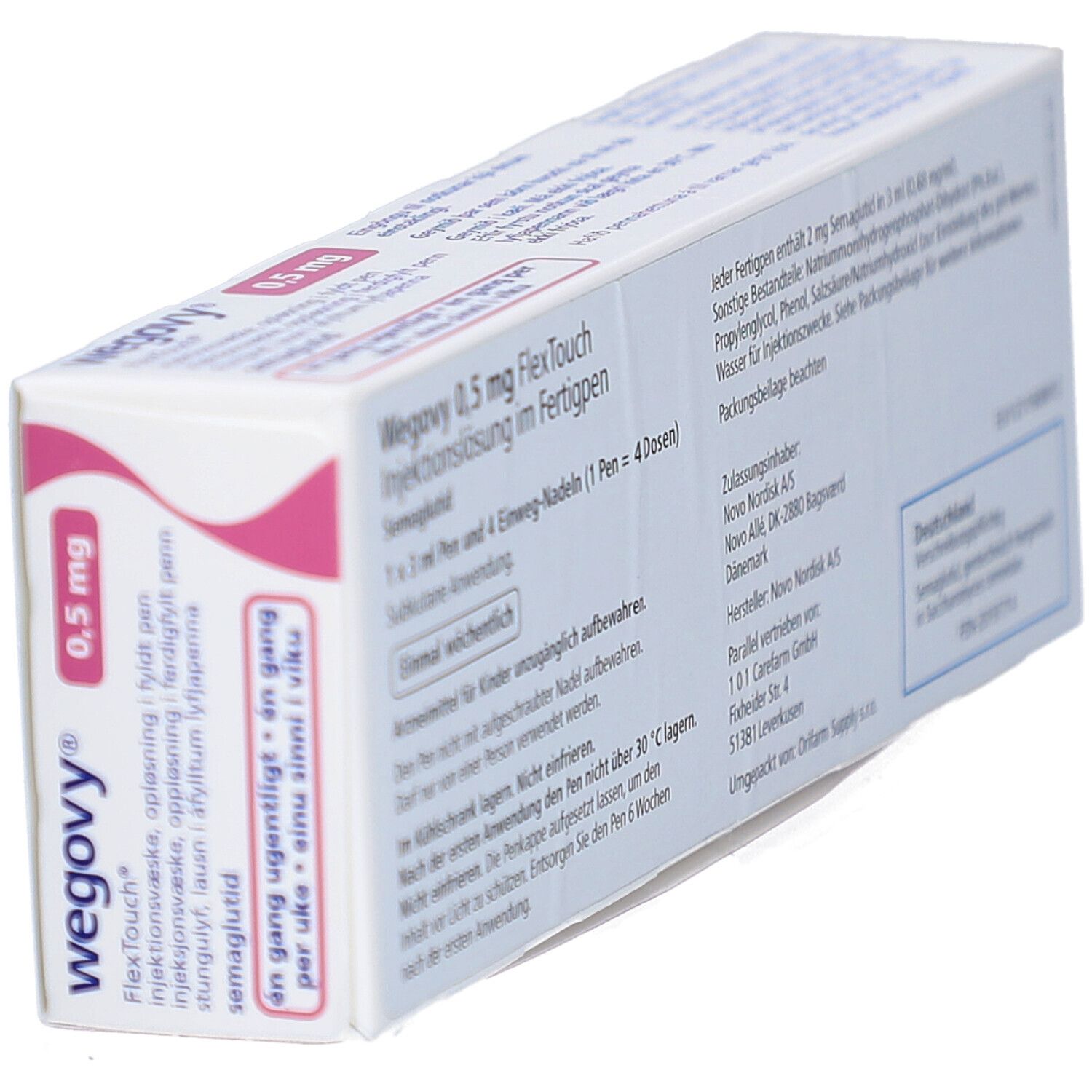 Schrägansicht der Rückseite der Wegovy 0,5 mg Verpackung. Textinformationen. Rosa Akzent.