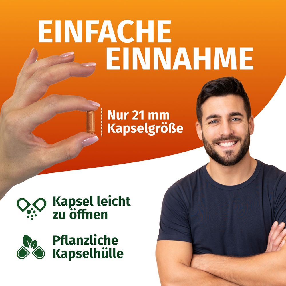 Mann lächelt, hält eine 21 mm Kapsel. Einfache Einnahme, pflanzliche Kapselhülle.