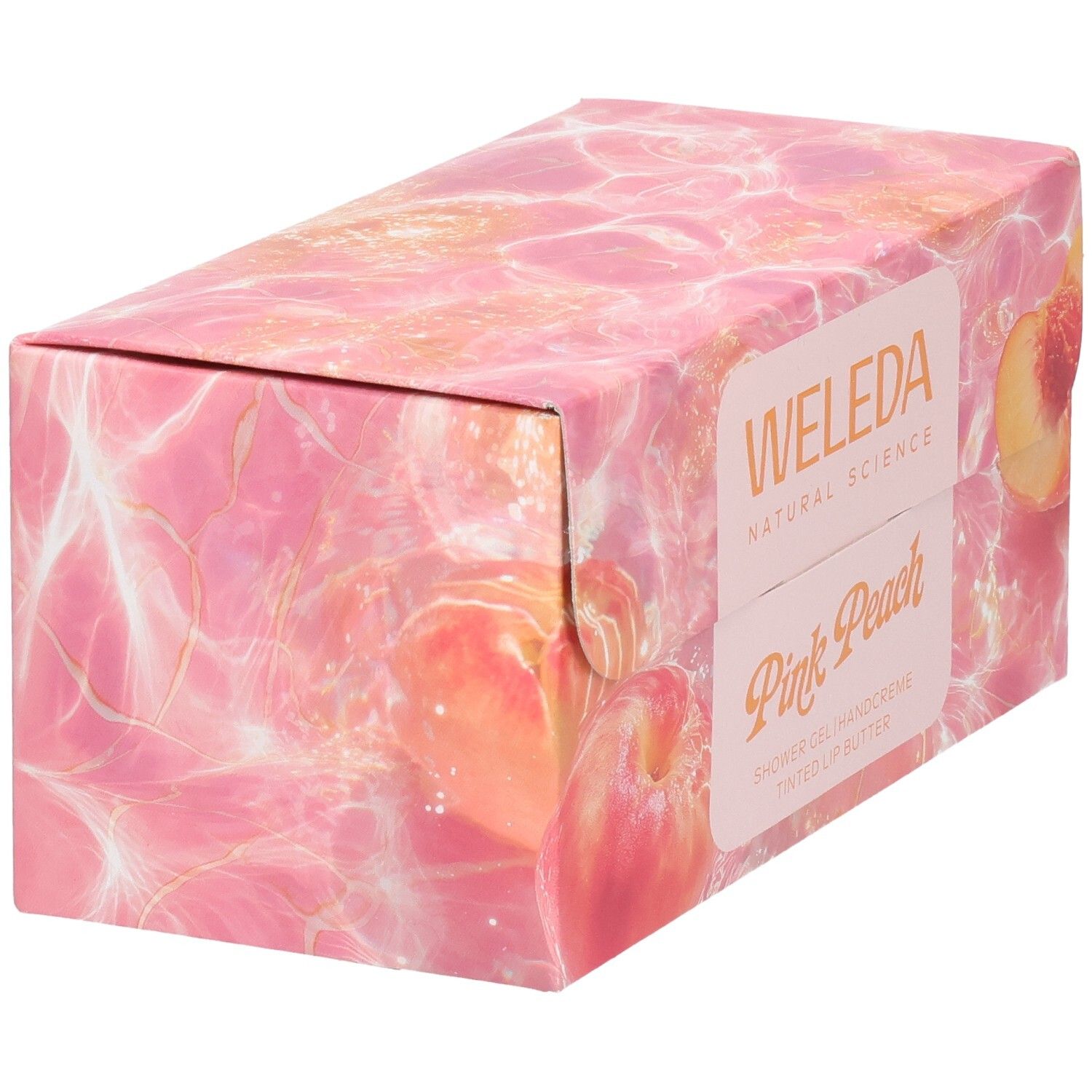 Geschenkset-Verpackung mit Pfirsich-Motiv. Aufschrift: Weleda, Pink Peach. Schräge Ansicht.