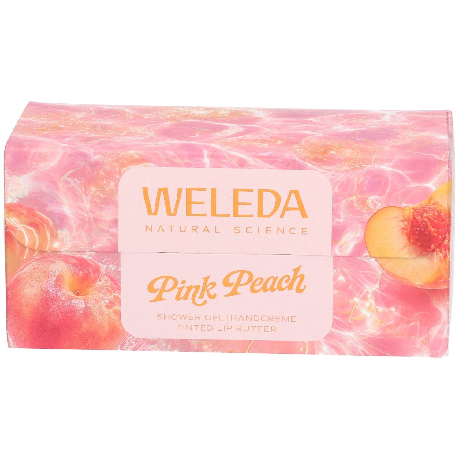 Geschenkset-Verpackung mit Pfirsich-Motiv. Aufschrift: Weleda, Pink Peach. Enthält Duschgel, Handcreme und Lippenbutter.