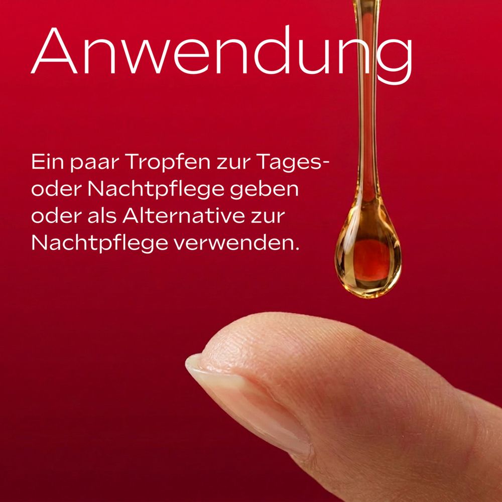 Tropfen Gesichtsöl fällt auf einen Finger.