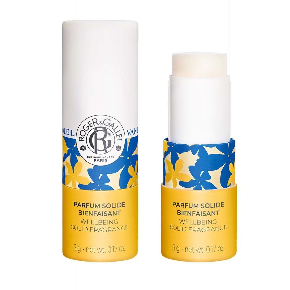 Zwei zylindrische Behälter. Einer geschlossen, einer geöffnet mit Produkt. Gelber Boden, blaue Blumen. Text: Parfum Solide.