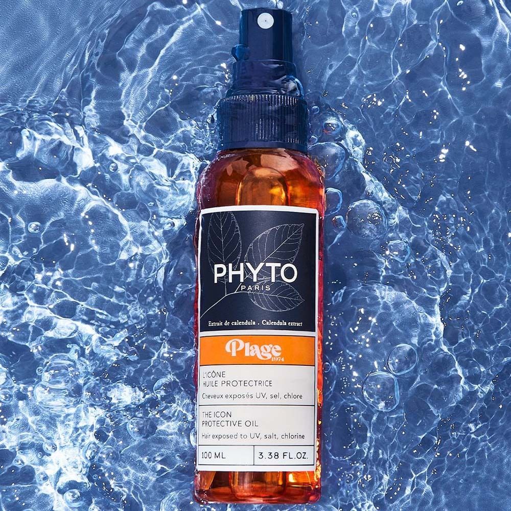 PHYTO Paris Plage The Icon Protective Oil Flasche mit Sprühkopf in Wasser.