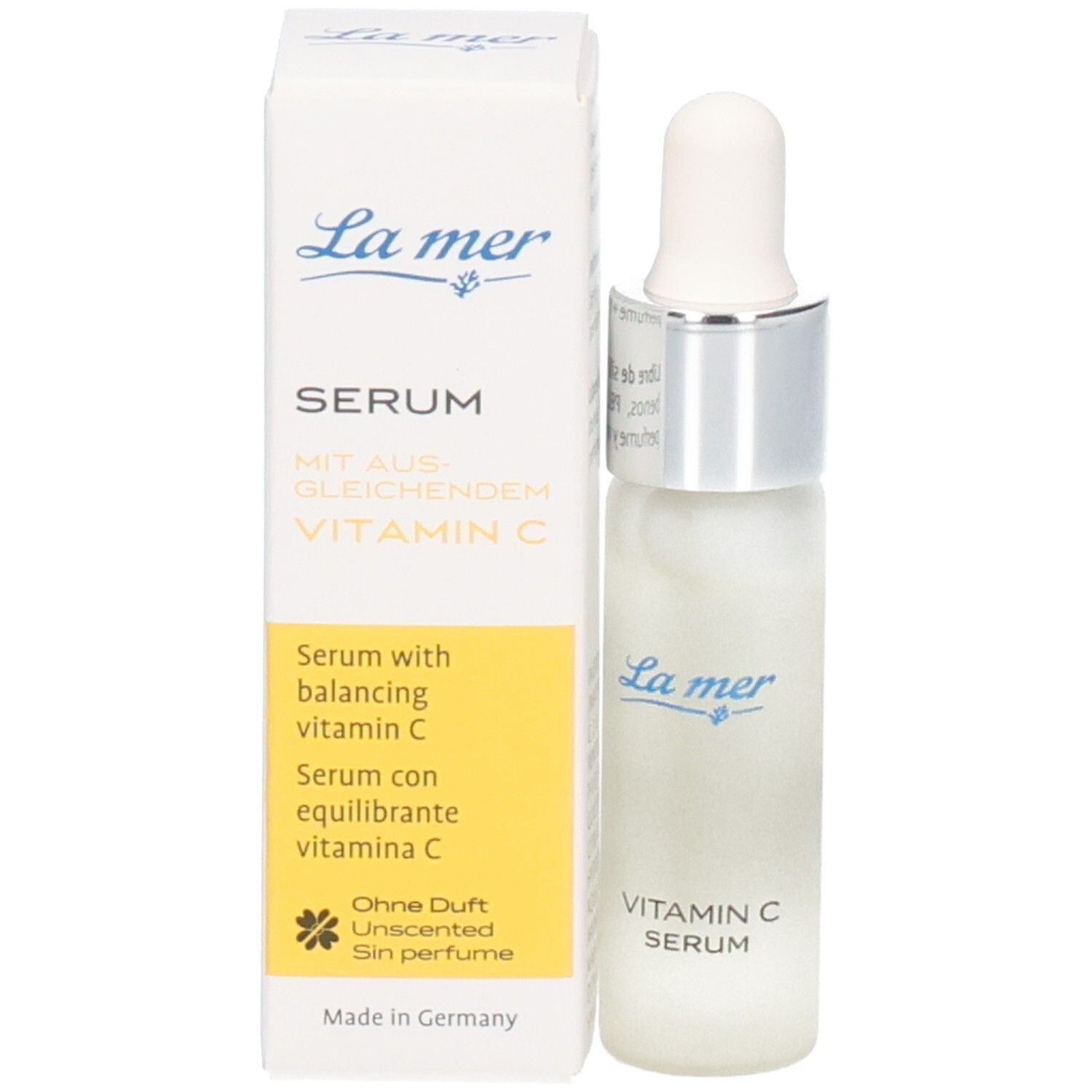 Serumflasche neben Verpackung. Verpackung: La mer, Serum, Vitamin C. Flasche: Vitamin C Serum.