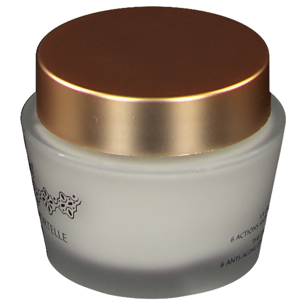 Pot en verre avec couvercle doré. Inscription: 6 actions anti-âge, The Cream, 6 anti-aging effects. Logo et texte.
