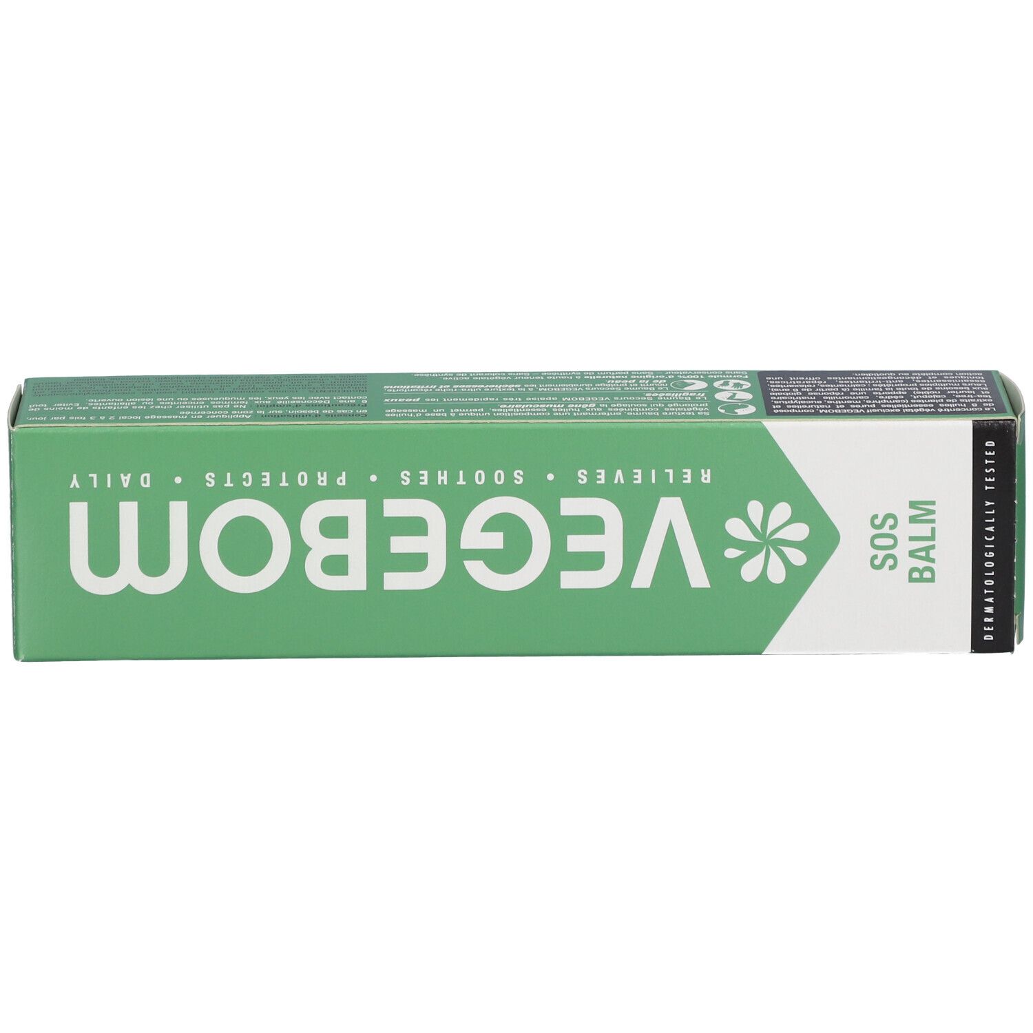 Oberseite der grünen Schachtel. Aufschrift: VEGEBOM, SOS BALM. Textinformationen: RELIEVES, SOOTHES, PROTECTS, DAILY.