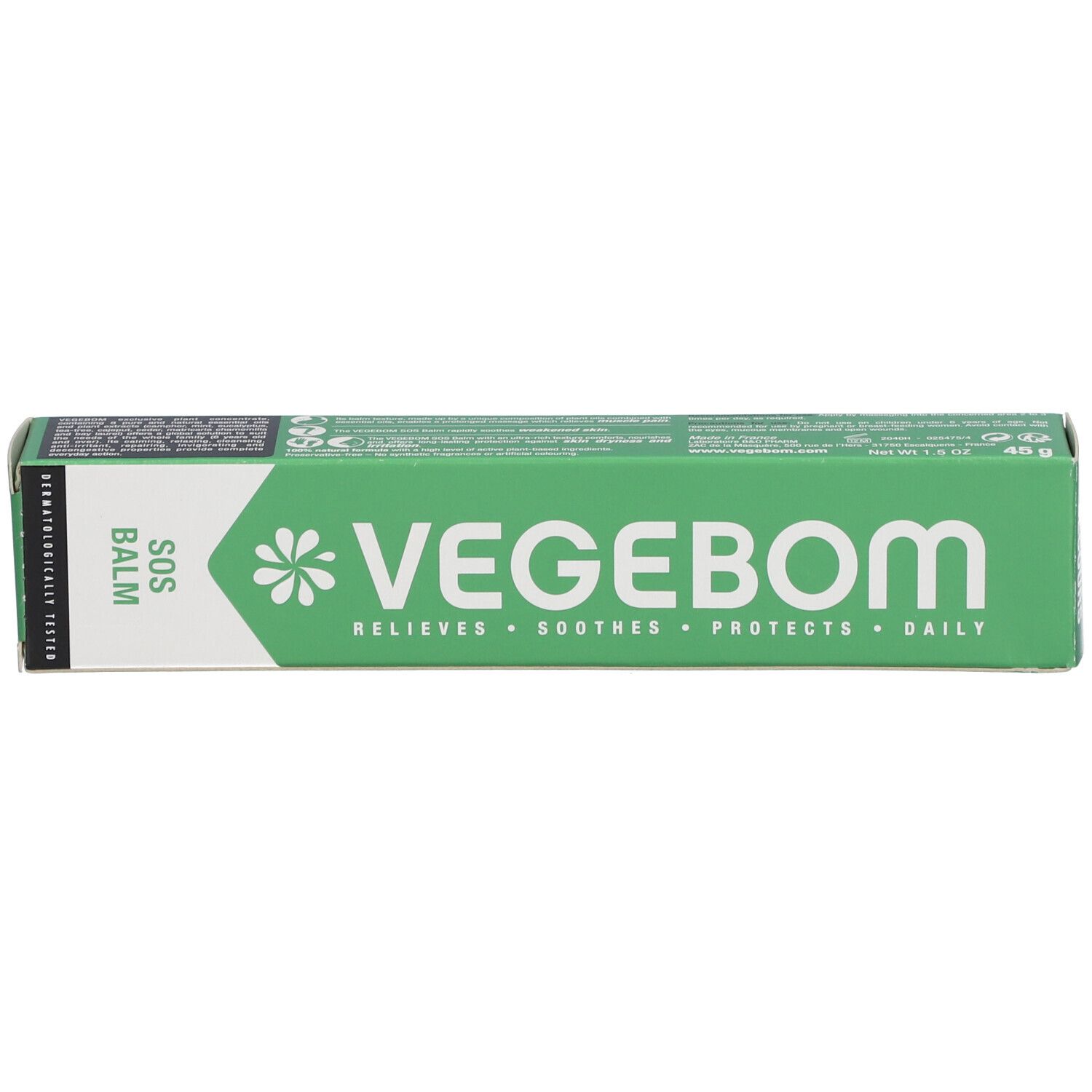 Boîte verte. Inscription: VEGEBOM, SOS BALM. Texte et logo blancs. Testé dermatologiquement.