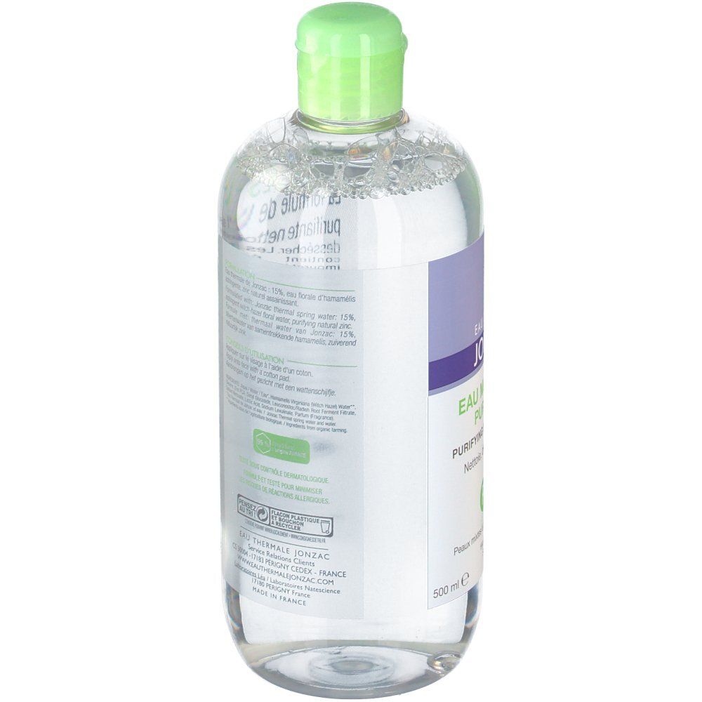 Flacon avec bouchon vert. Contient un liquide clair. Étiquette avec texte. 500 ml.