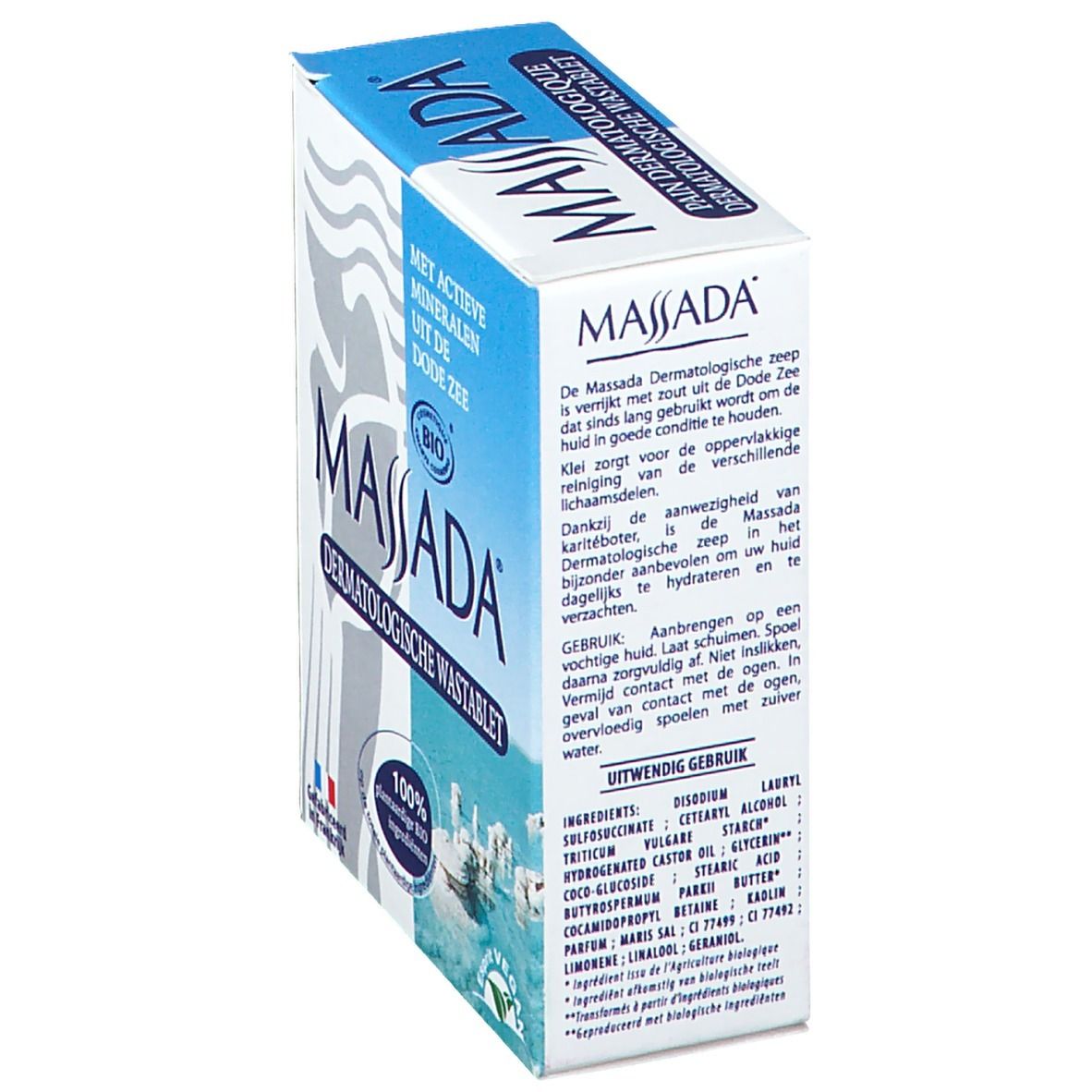 Boîte de savon dermatologique Massada, en biais. Texte sur le côté : ingrédients, mode d'emploi, certification bio, label vegan, origine France.