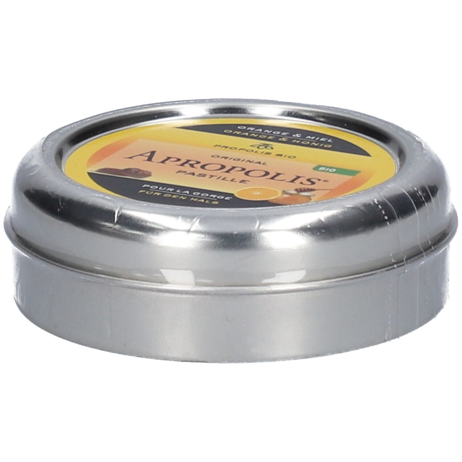Runde Dose, leicht schräg. Gelbes Etikett mit Aufschrift: Apropolis Pastille. Dose in Folie verpackt.