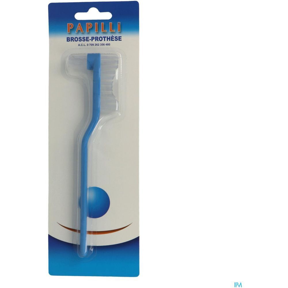 Brosse pour prothèse bleue, emballée. Manche courbé. Inscription "Papilli Brosse-Prothèse" sur l'emballage.