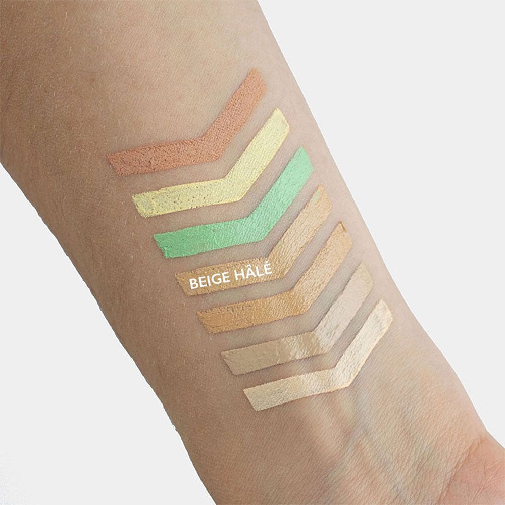 Arm mit Farbmustern von Concealern. Die Farben sind beige, gelb und grün. Aufgedruckt: BEIGE HALE.