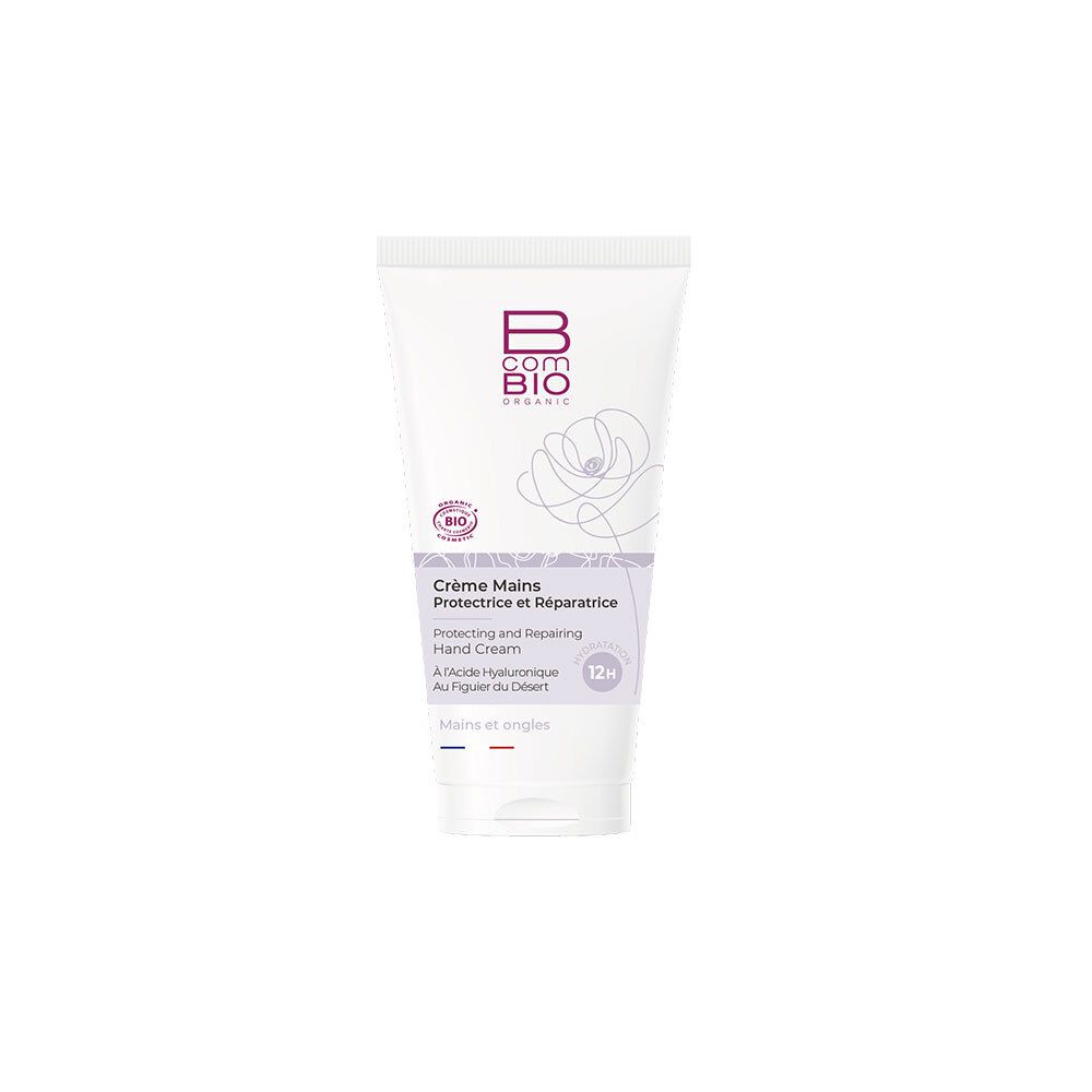 Tube blanc, accents violets. Inscription: B COM BIO, Crème Mains Protectrice et Réparatrice. Label bio. 12h.
