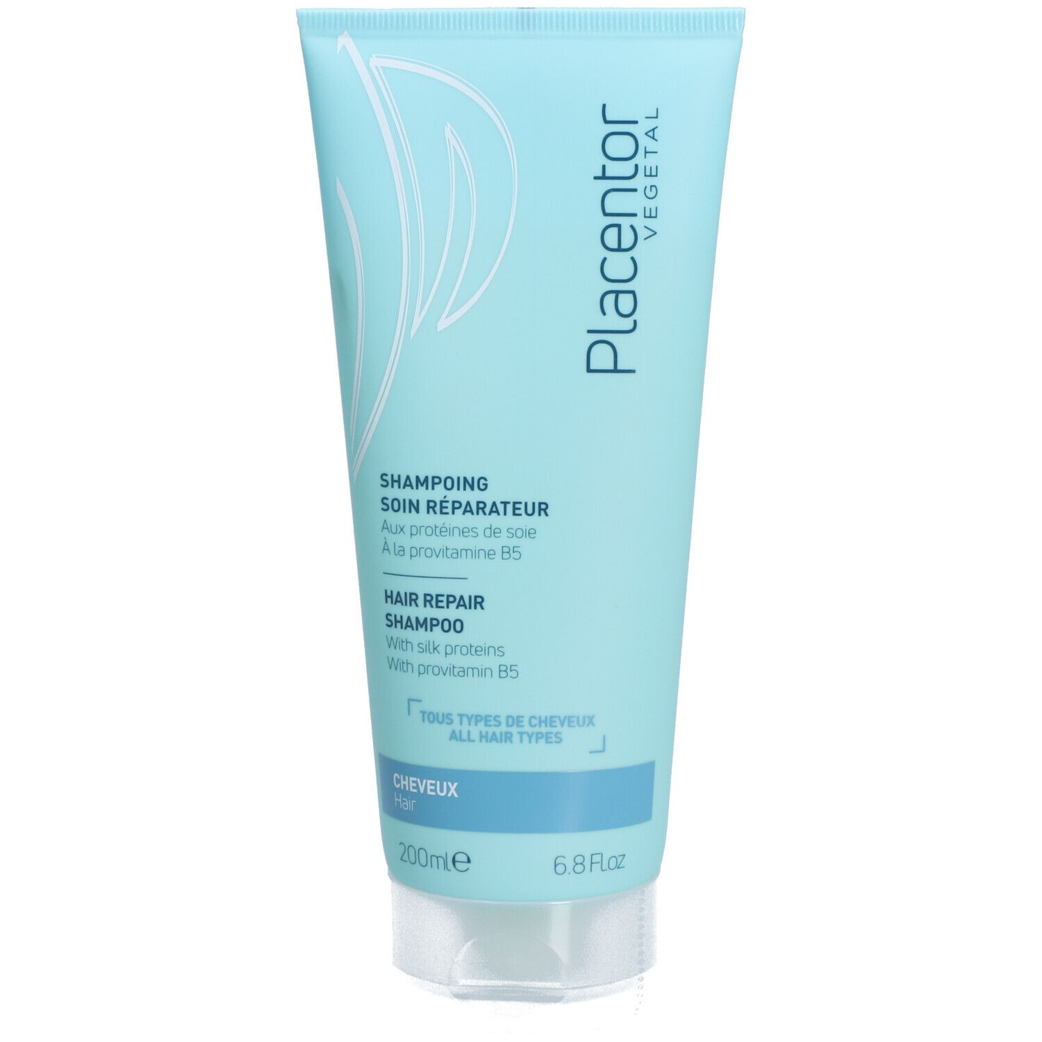 Tube bleu clair. Inscriptions: Placentor Vegetal, SHAMPOING SOIN RÉPARATEUR, HAIR REPAIR SHAMPOO. Bouchon transparent.