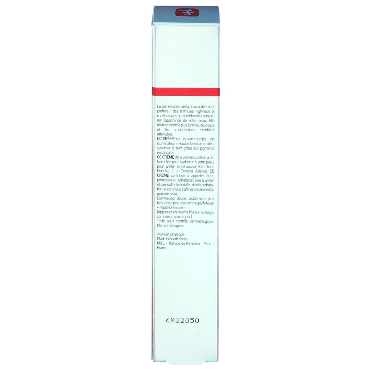 Boîte avec texte. Nom du produit non visible. Texte en plusieurs langues. Couvercle rouge.