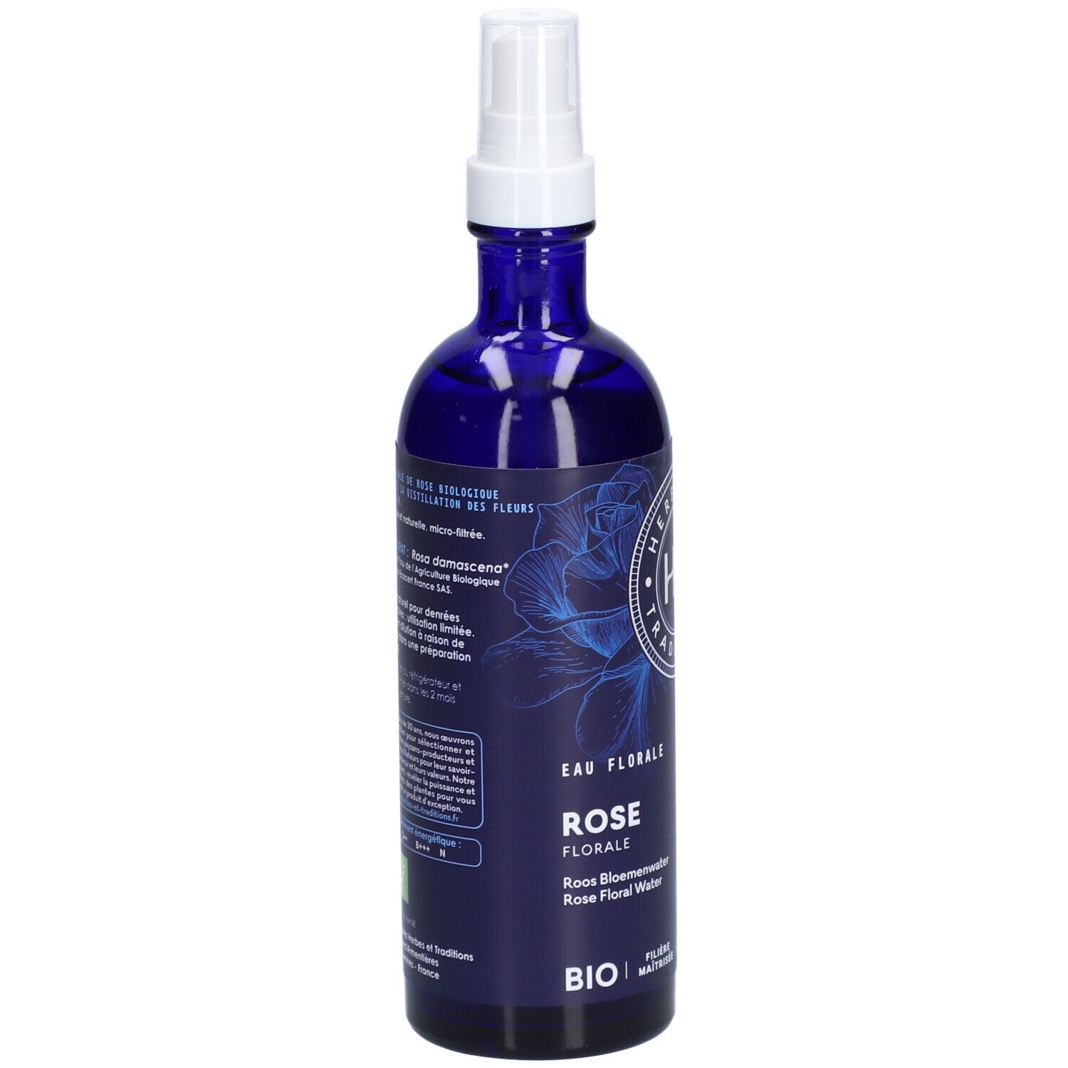 Flacon en verre bleu avec vaporisateur. Étiquette avec texte: "EAU FLORALE ROSE". Label BIO.