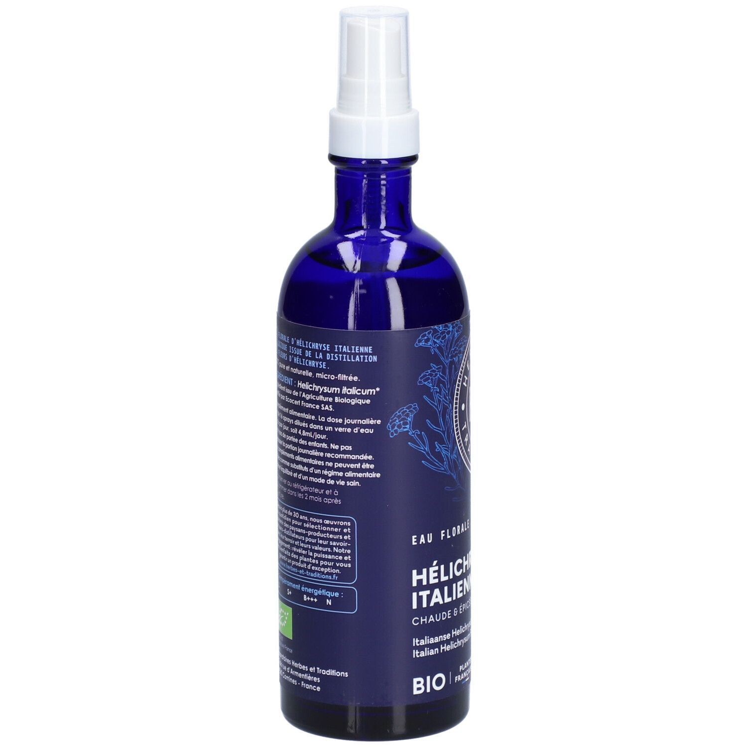 Flacon en verre bleu avec vaporisateur. Étiquette avec texte et logo: H&T. Dos avec texte en plusieurs langues.
