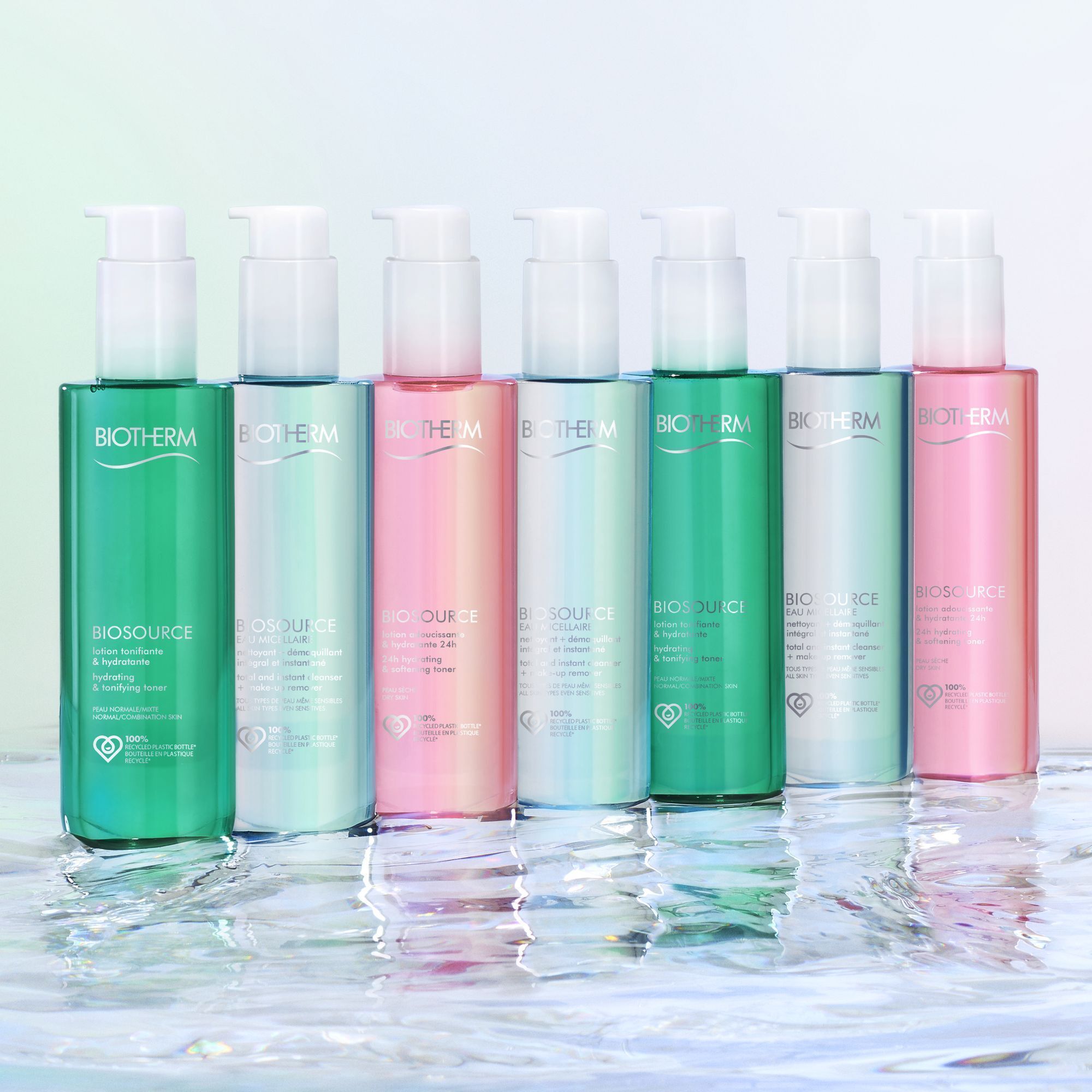 Plusieurs flacons BIOTHERM Biosource Lotion. Différentes couleurs. Pompe blanche. Sur l'eau.