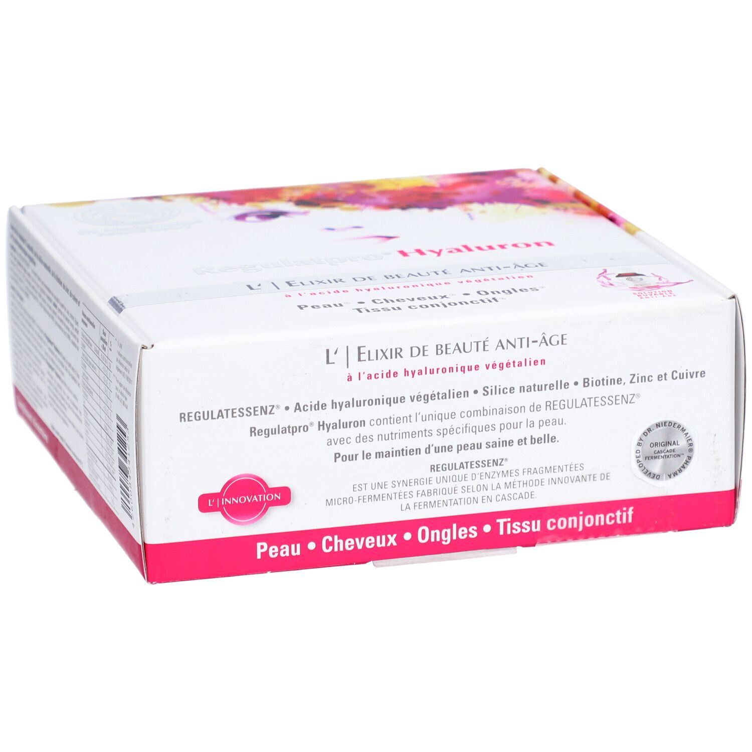 Weißer Karton mit rosa Akzenten. Text: L'Elixir de Beauté Anti-Âge, Regulatessenz Hyaluron. Enthält Biotin, Zink und Kupfer. Siegel.
