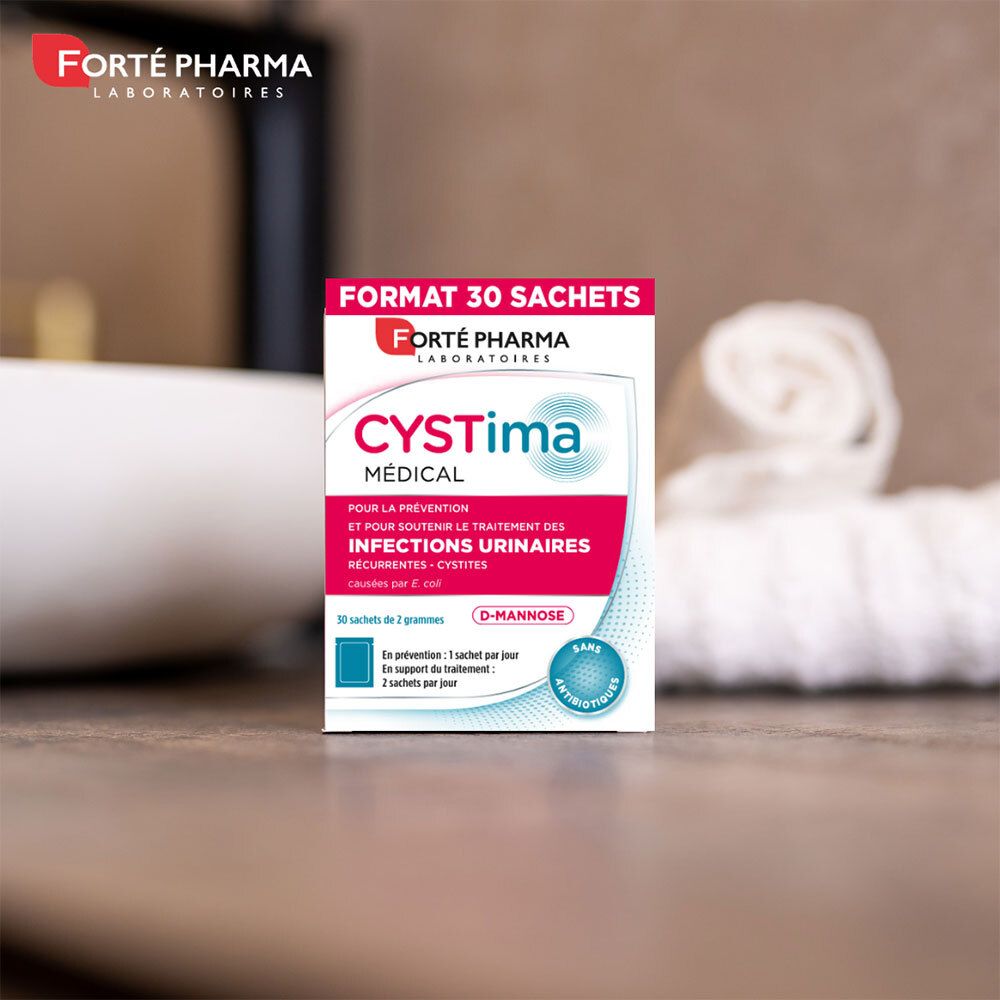 Petite boîte CYSTima Médical. Marque Forté Pharma. Texte: Pour infections urinaires. Sur table.
