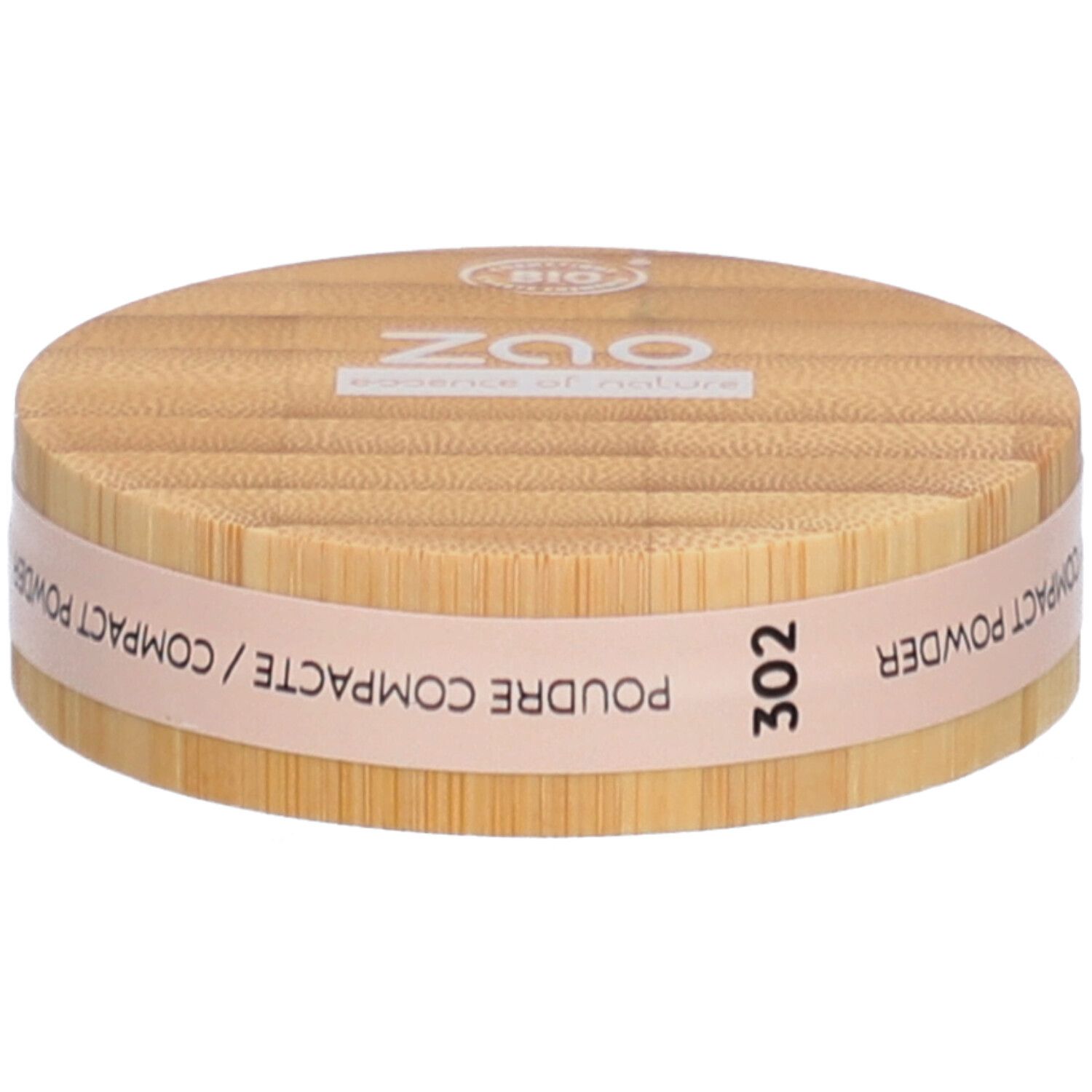 Ronde compactpoederdoos van hout. Opschrift: ZAO, 302, POUDRE COMPACTE. Bio-certificering.