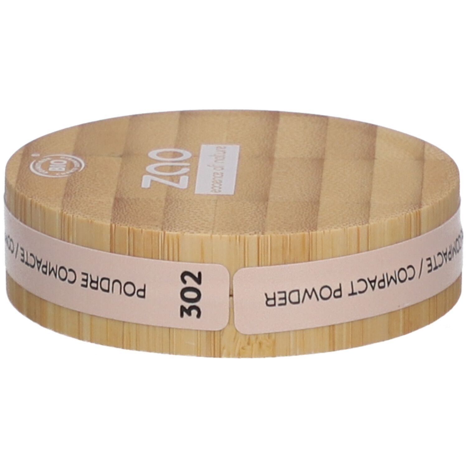 Ronde compactpoederdoos van hout. Opschrift: ZAO, 302, POUDRE COMPACTE. Bio-certificering.