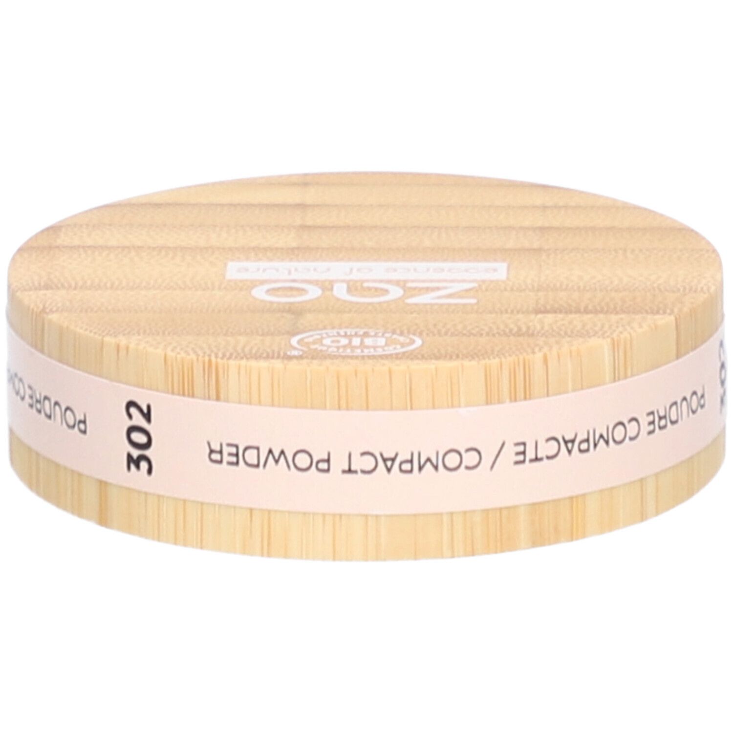 Ronde compactpoederdoos van hout. Opschrift: ZAO, 302, POUDRE COMPACTE. Bio-certificering.