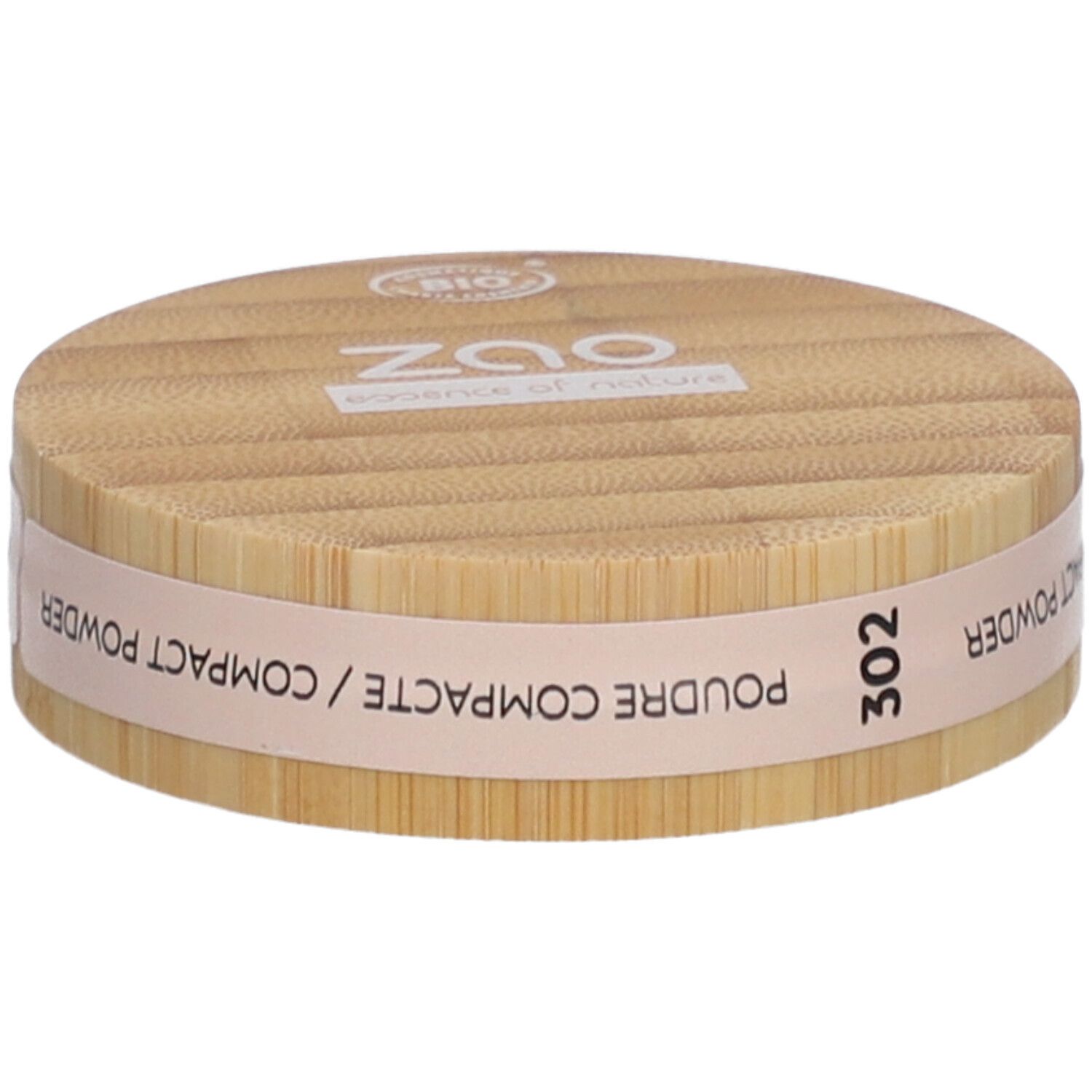 Ronde compactpoederdoos van hout. Opschrift: ZAO, 302, POUDRE COMPACTE. Bio-certificering.