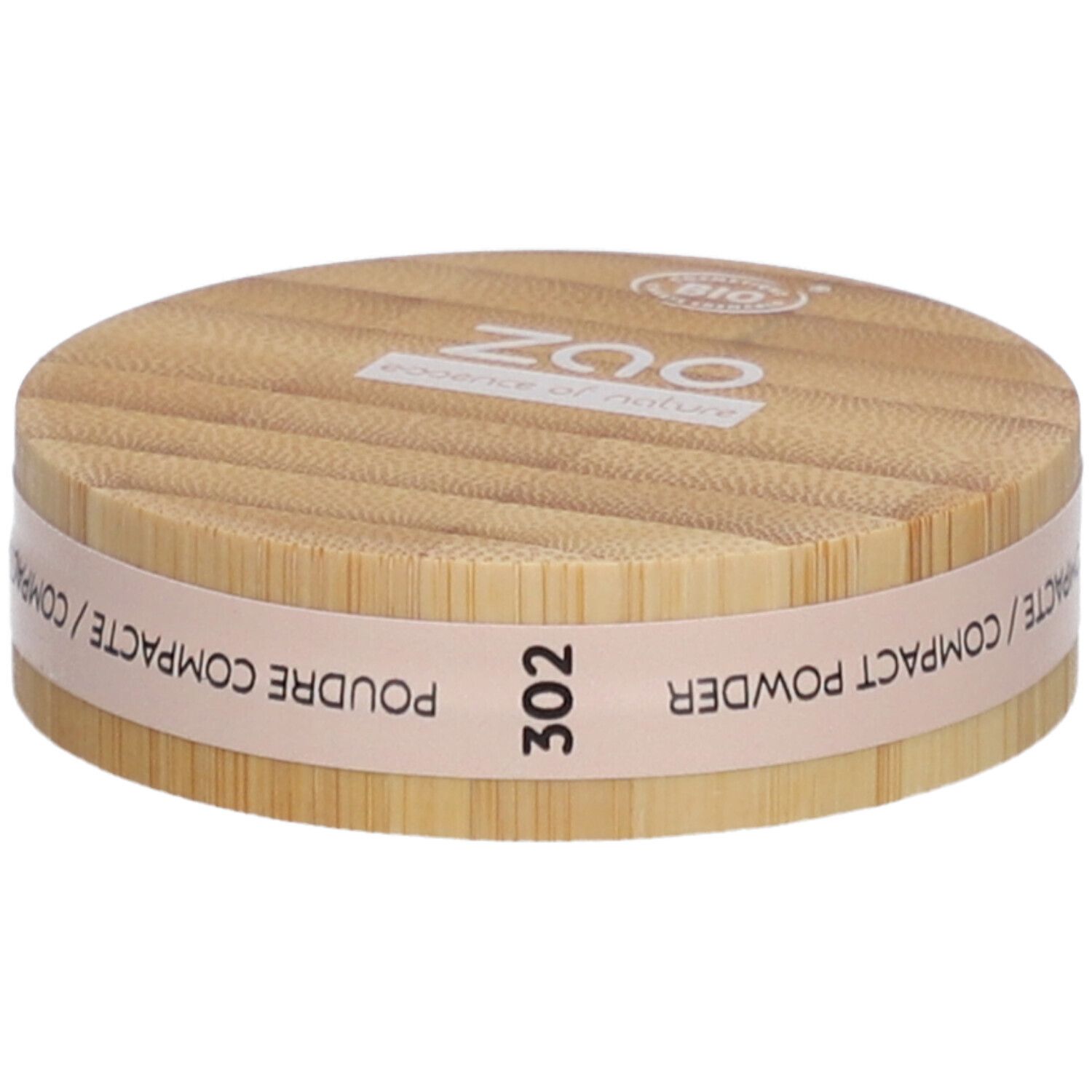 Ronde compactpoederdoos van hout. Opschrift: ZAO, 302, POUDRE COMPACTE. Bio-certificering.
