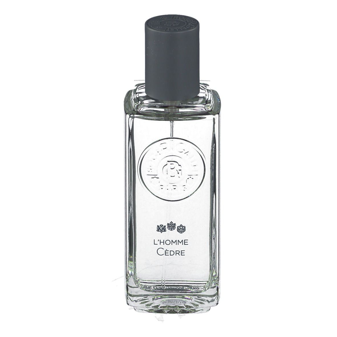 Flacon transparent avec bouchon gris. Inscription : L'Homme Cèdre. Logo et texte sur l'étiquette.
