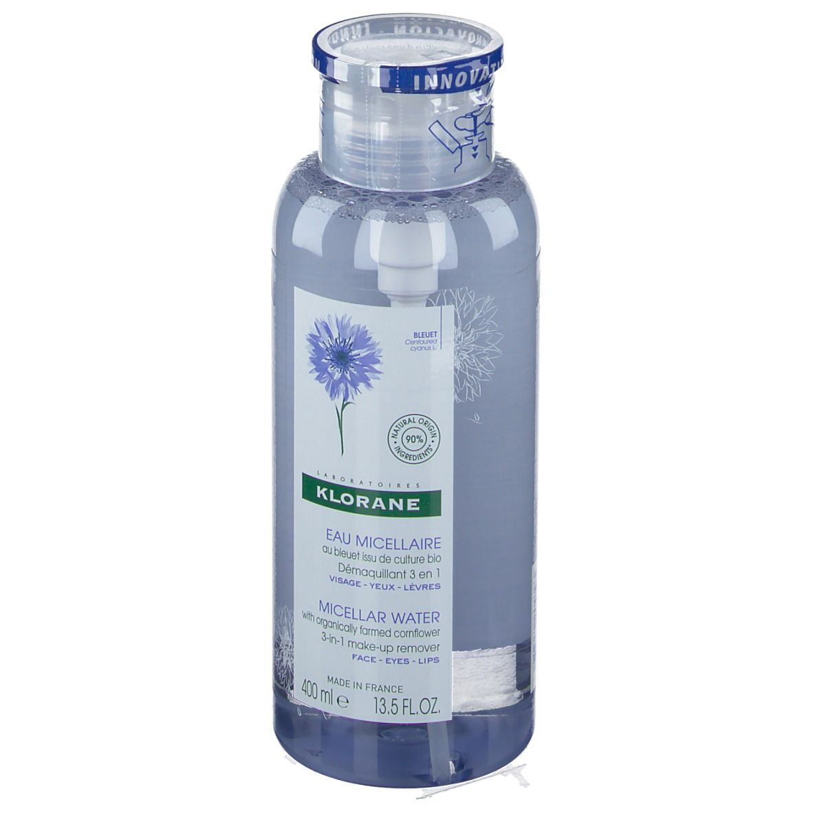 Flacon transparent avec liquide bleu. Étiquette avec nom du produit et illustration de bleuet. Bouchon avec bande bleue.
