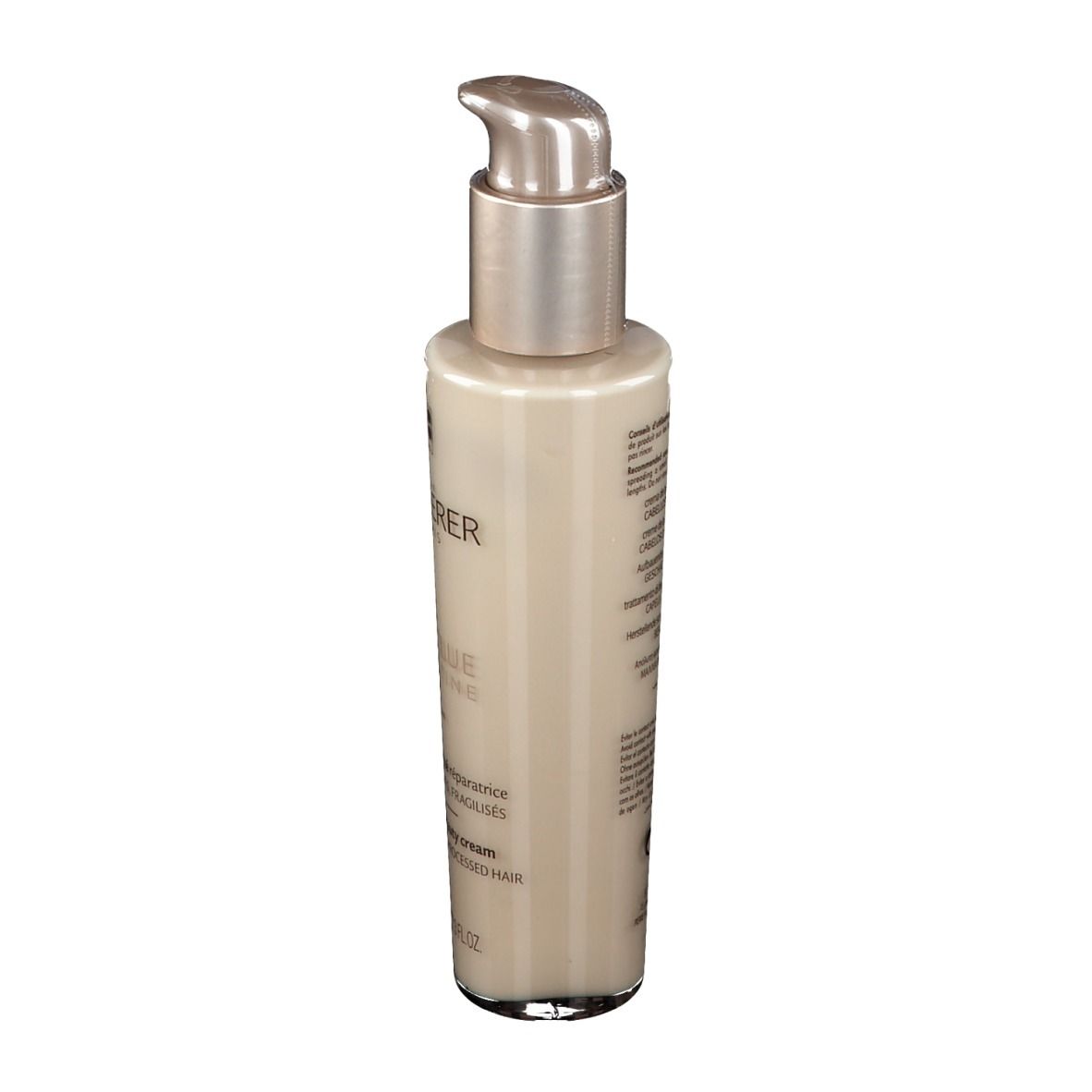 Flacon beige avec pompe argentée. Texte au dos. Produit pour cheveux abîmés.