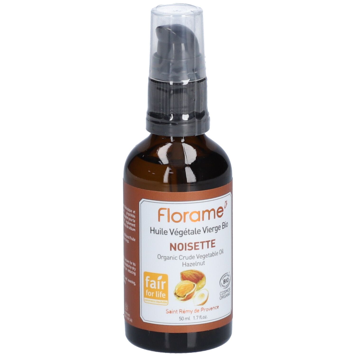 Bruine glazen fles met pomp. Etiket met productnaam, hazelnootillustratie en bio-keurmerk. Fair for Life-logo.