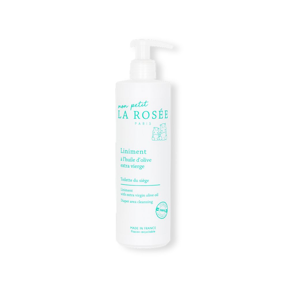 Flacon blanc avec pompe. Inscription: LA ROSÉE, Liniment à l'huile d'olive extra vierge. Pour bébés. Fabriqué en France.