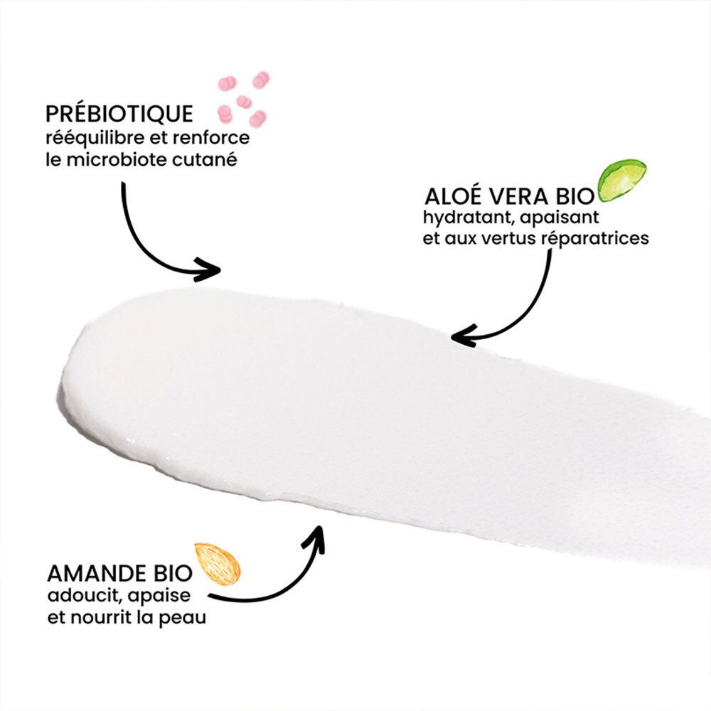 Éclaboussure de crème blanche avec flèches et texte. Prébiotiques, Aloe Vera, amande bio. Texte en français.
