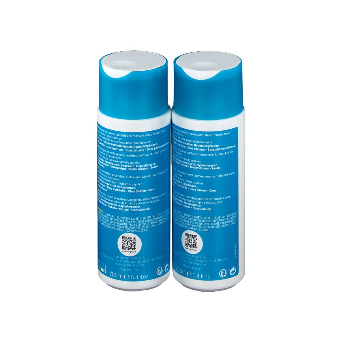 Zwei Flaschen Cystiphane Biorga Shampoo, Rückseite. Blaue Schrift auf weißem Hintergrund. QR-Code und Text.