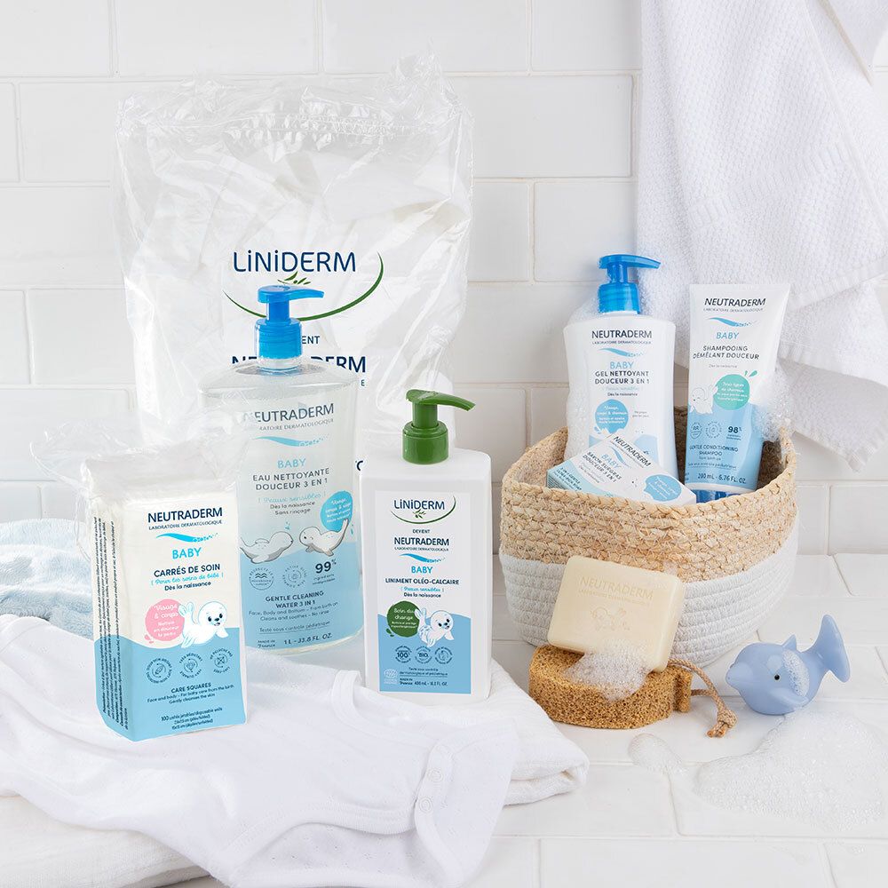 Verschiedene Neutraderm Baby Produkte. Reinigungswasser, Waschlotion, Feuchttücher. Auf weißem Hintergrund. Korb mit Accessoires.
