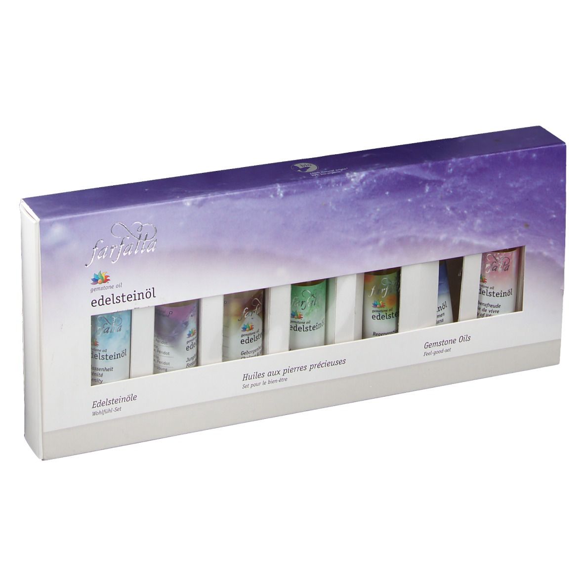 Coffret de bien-être farfalla Edelsteinöle. Six petits flacons dans une boîte blanche avec fenêtre. Inscriptions en allemand, français et anglais.