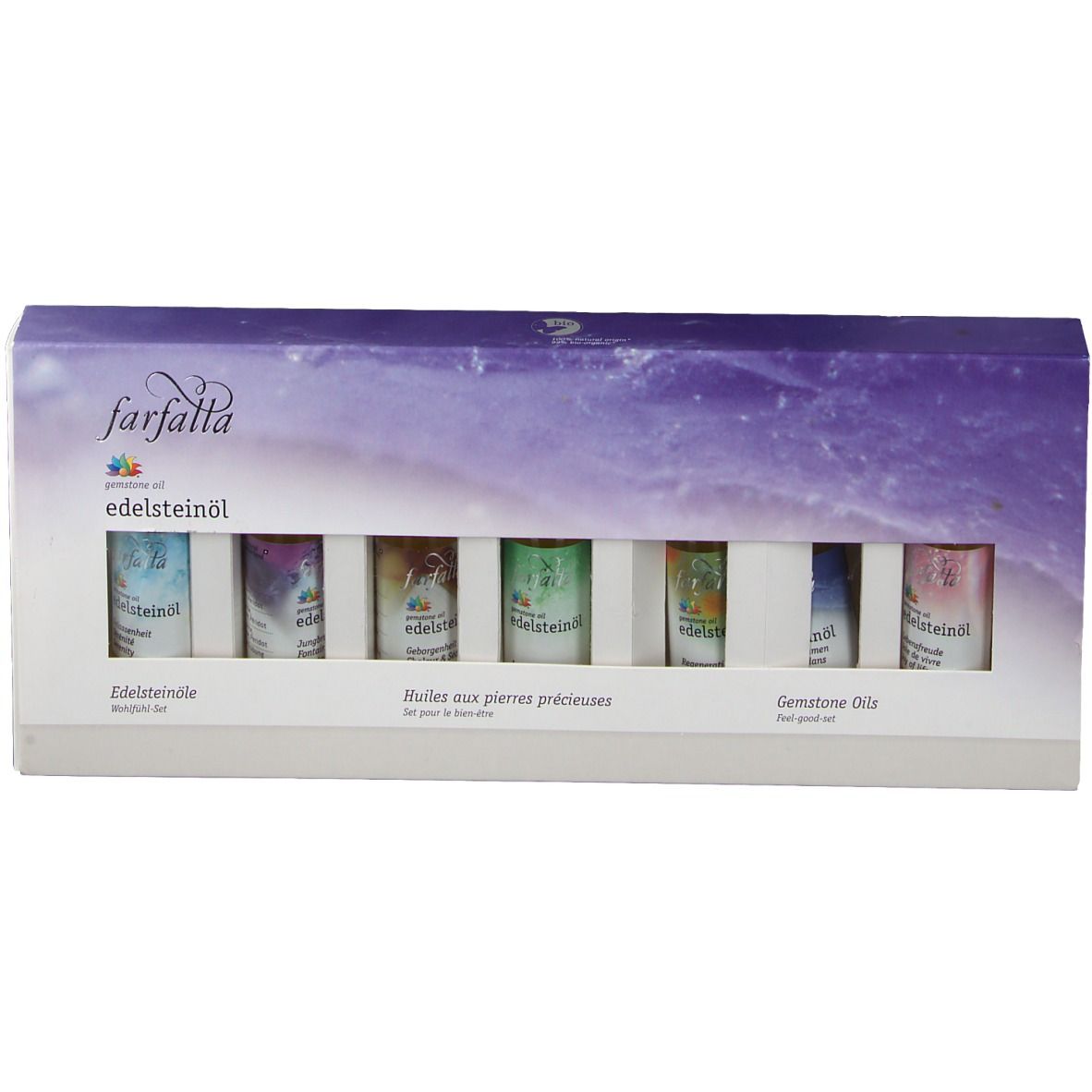 Coffret de bien-être farfalla Edelsteinöle. Six petits flacons dans une boîte blanche avec fenêtre. Inscriptions en allemand, français et anglais.