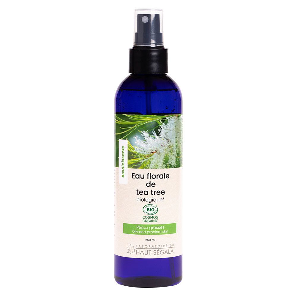 Blaue Flasche mit Sprühkopf. Etikett mit Text: Eau florale de tea tree biologique. Bio-Zertifizierung.