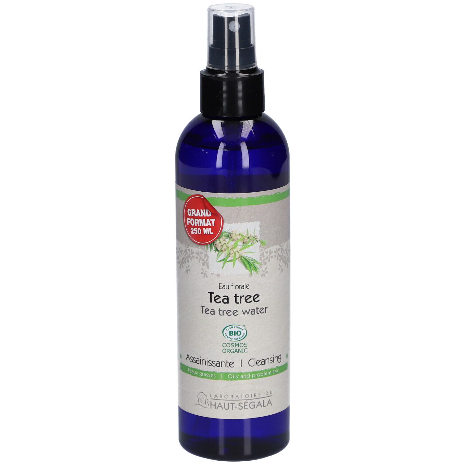 Blaue Flasche mit Sprühkopf. Etikett mit Text: Eau florale de tea tree. Bio-Zertifizierung. Großes Format.