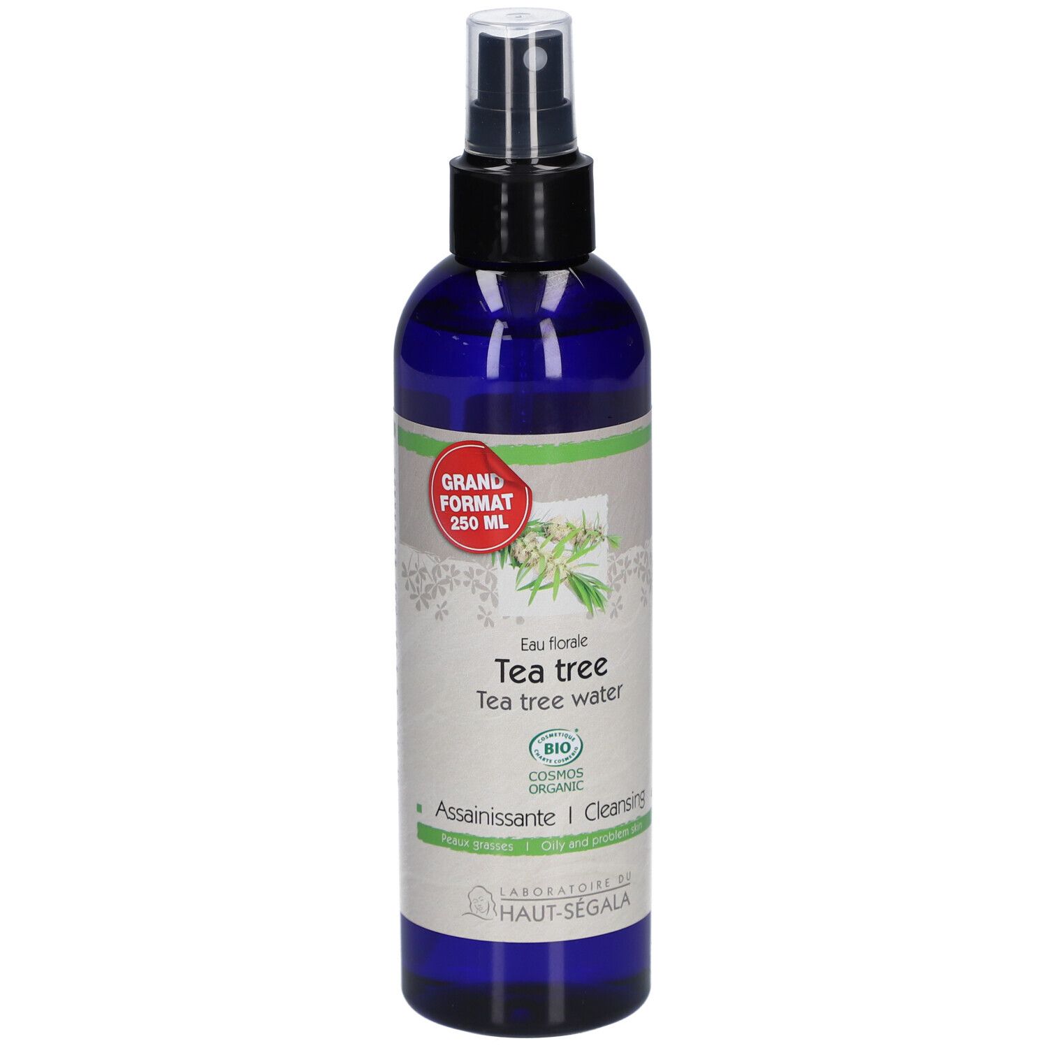 Blaue Flasche mit Sprühkopf. Etikett mit Text: Eau florale de tea tree. Bio-Zertifizierung. Großes Format.
