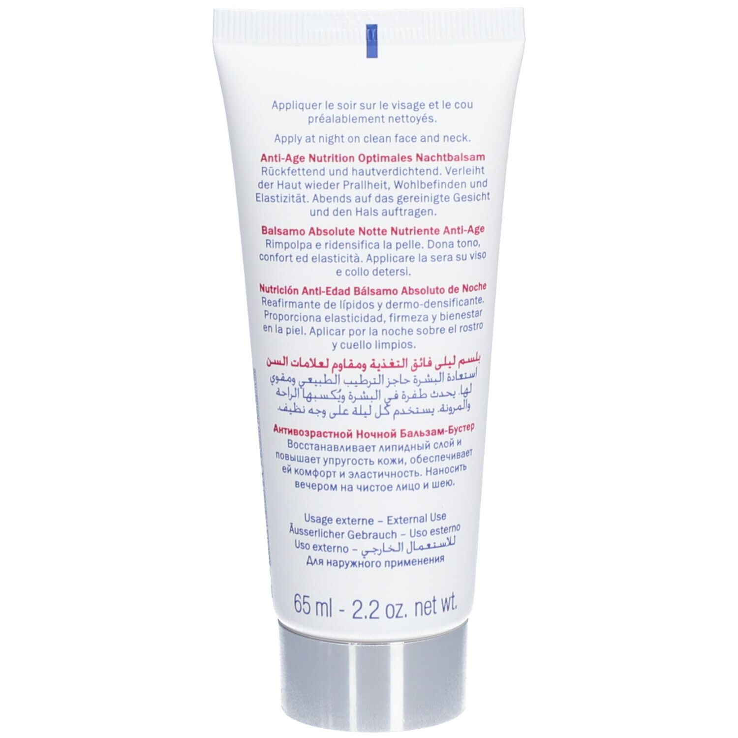 Dos du tube de crème. Texte multilingue : Application, Baume de Nuit Absolu, etc. Bouchon argenté.