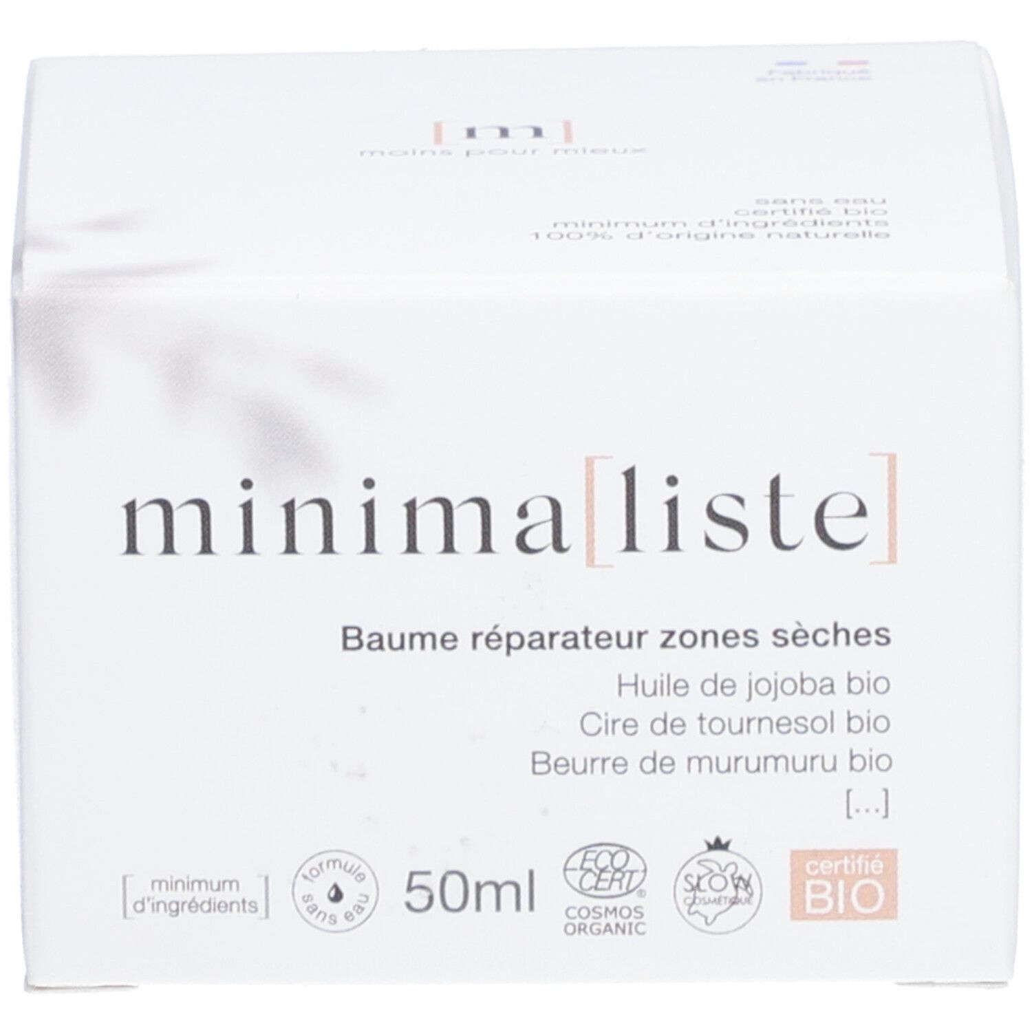 Emballage du produit. Inscription : minimaliste, Baume réparateur zones sèches. Contient huile de jojoba, cire de tournesol, beurre de murumuru. 50ml.
