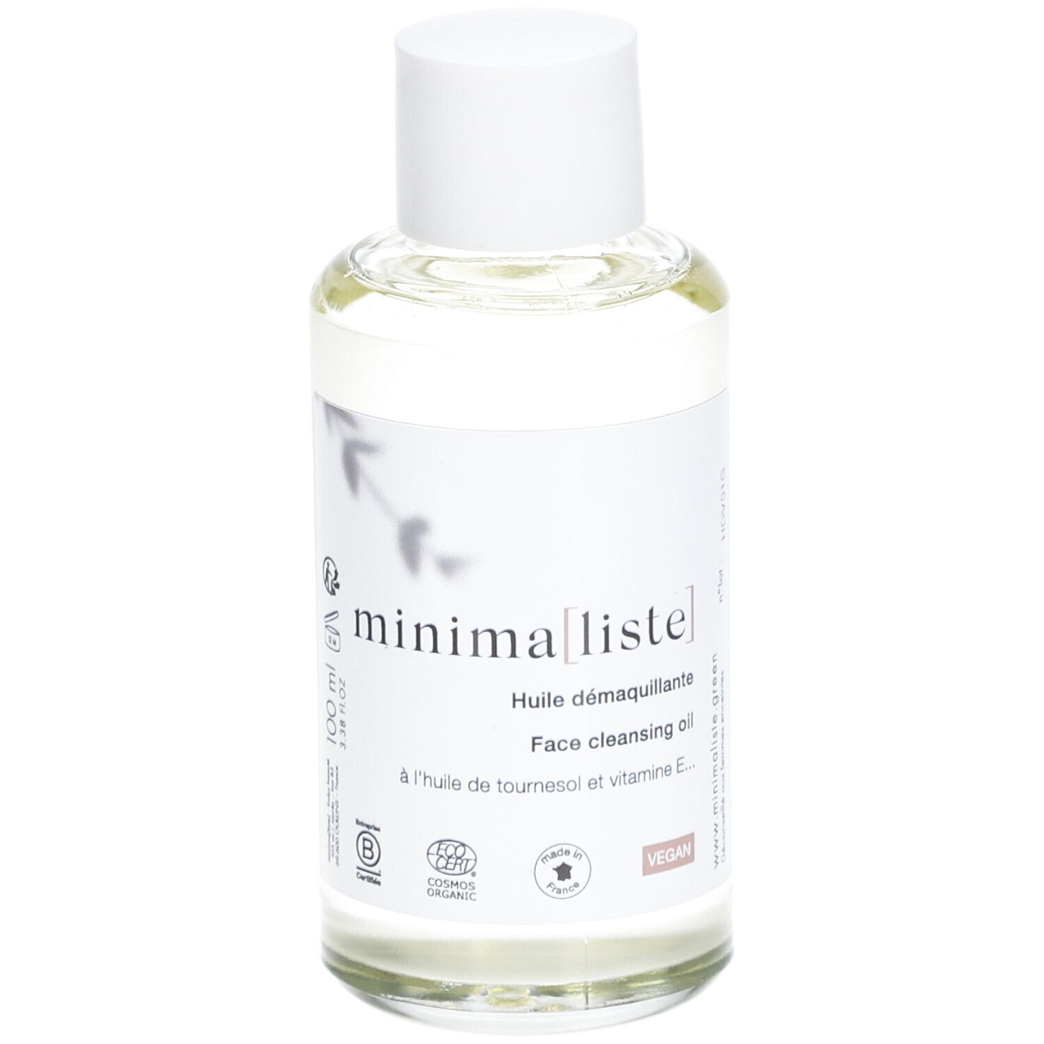 Flacon en verre transparent avec bouchon blanc et étiquette. Inscription : minima[liste]. Face cleansing oil. Vegan. Cosmos Organic.