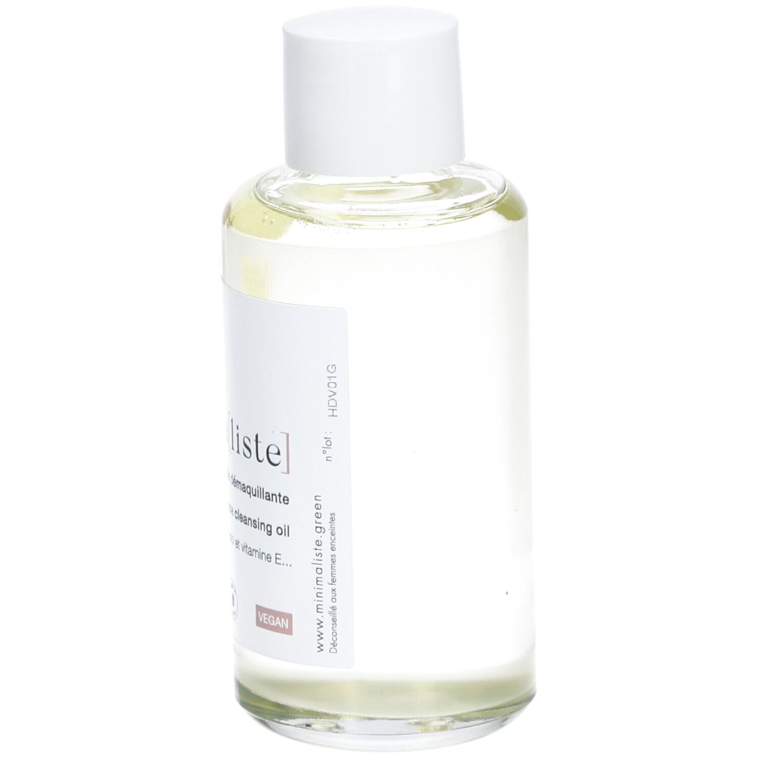 Flacon en verre transparent avec bouchon blanc et étiquette. Inscription : minima[liste]. Face cleansing oil. Vegan.