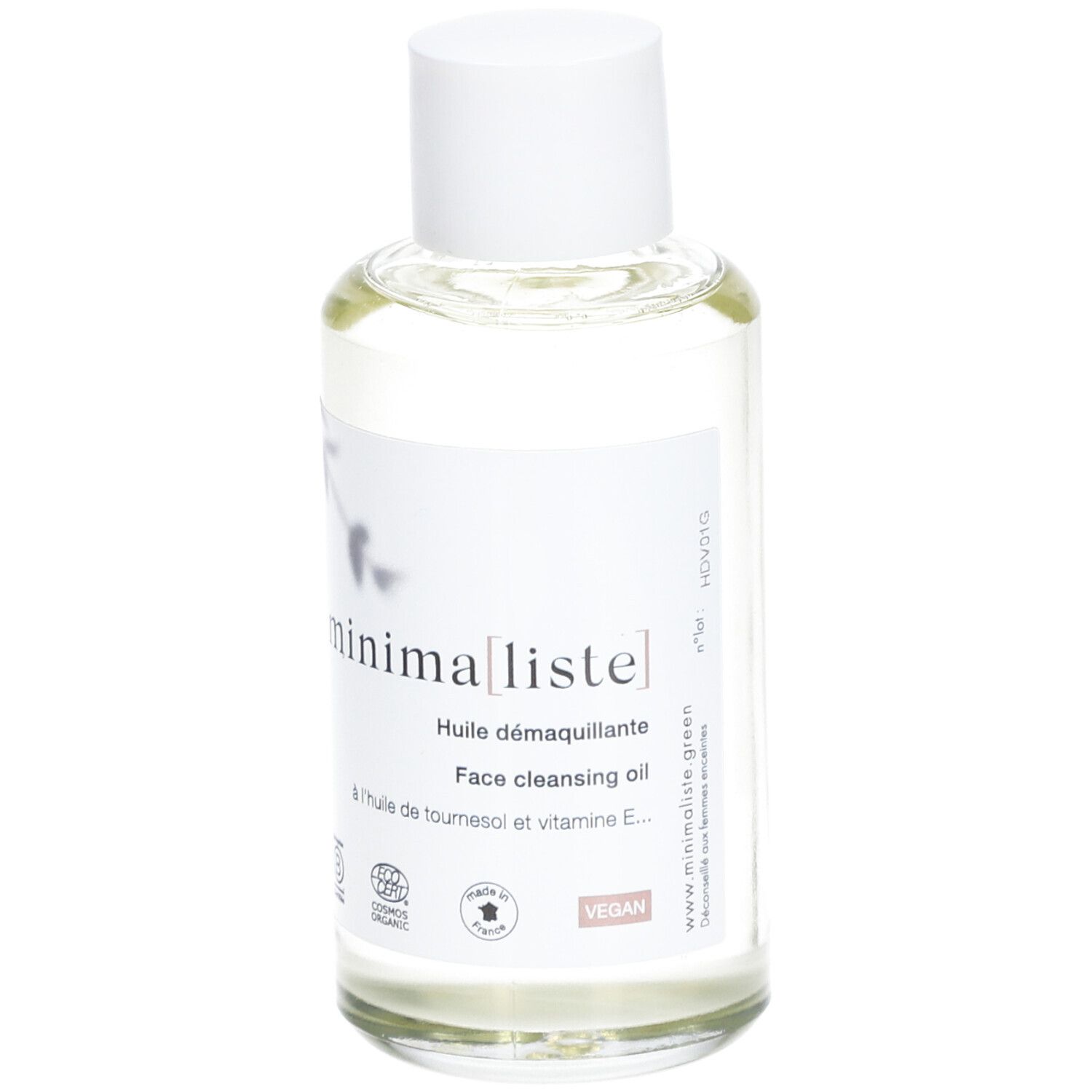 Flacon en verre transparent avec bouchon blanc et étiquette. Inscription : minima[liste]. Face cleansing oil. Vegan.
