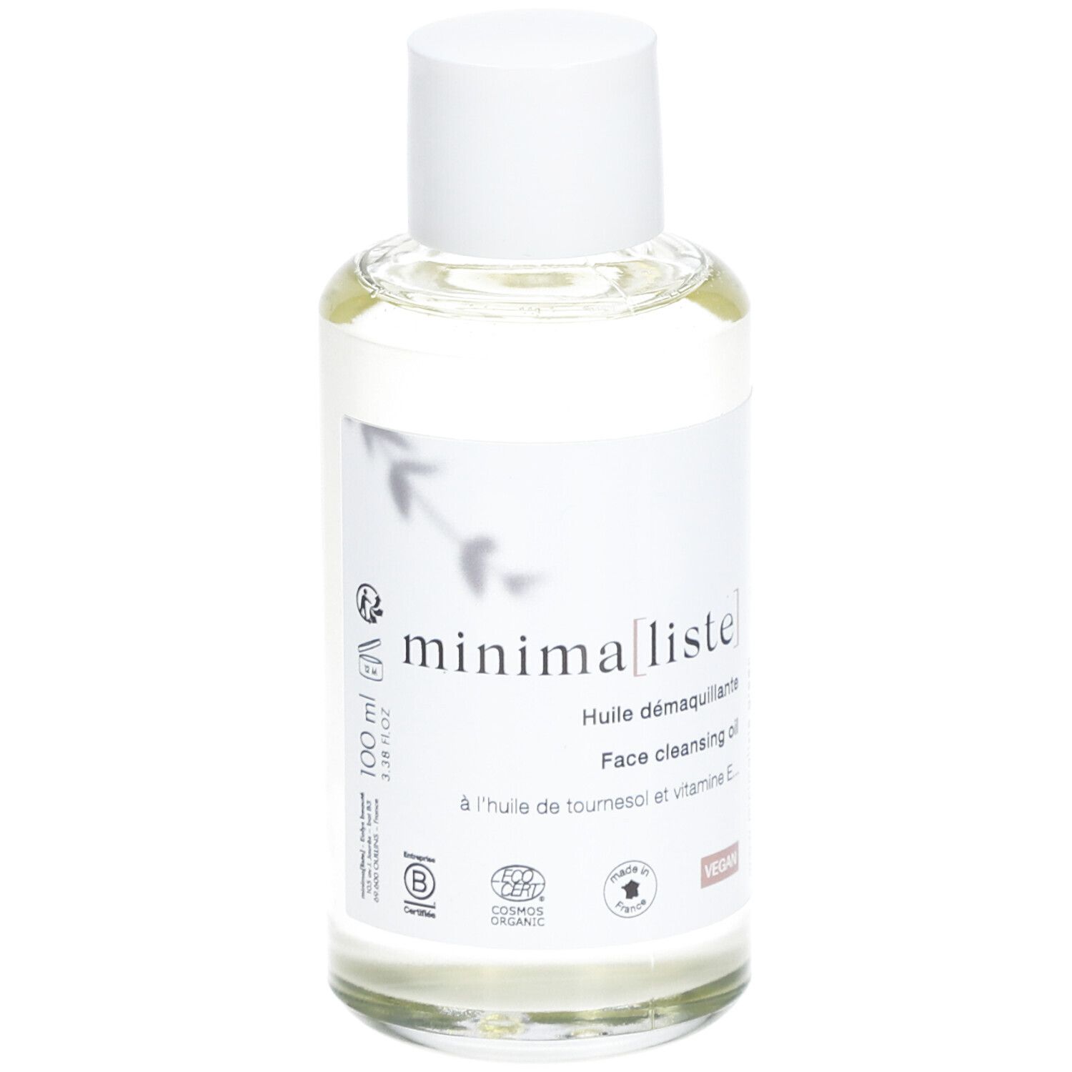 Flacon en verre transparent avec bouchon blanc et étiquette. Inscription : minima[liste]. Face cleansing oil. Vegan. 100 ml.