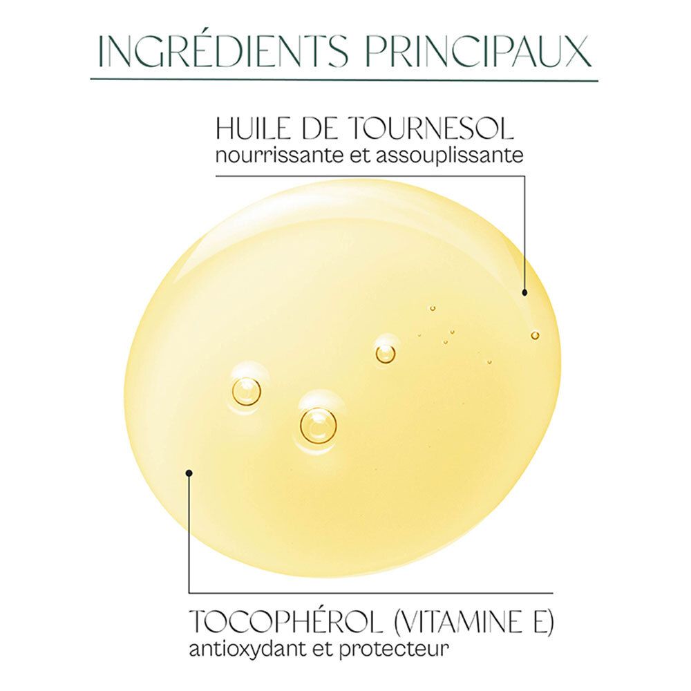 Gros plan d'un liquide jaune avec du texte. Texte : HUILE DE TOURNESOL, TOCOPHÉROL (VITAMINE E).