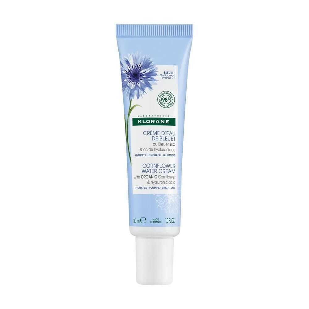 Tube bleu clair avec fleur bleue et texte. Contient Crème d'Eau de Bleuet. 30ml. 98% d'ingrédients naturels.